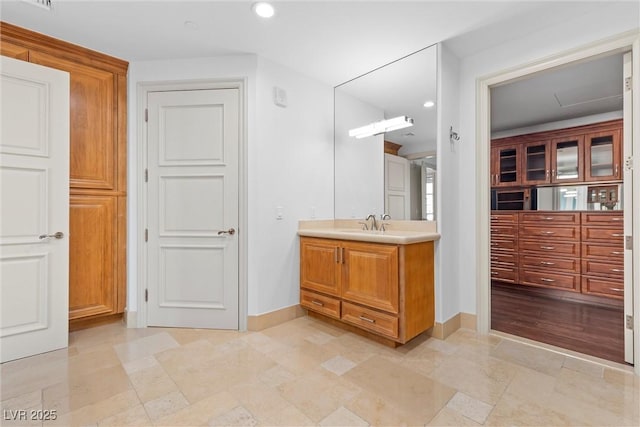 bathroom with recessed lighting, baseboards, and vanity