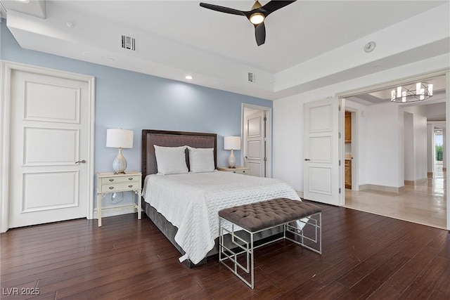 bedroom featuring visible vents, a ceiling fan, and hardwood / wood-style flooring