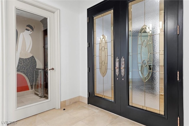 entryway with tile patterned floors, french doors, and baseboards