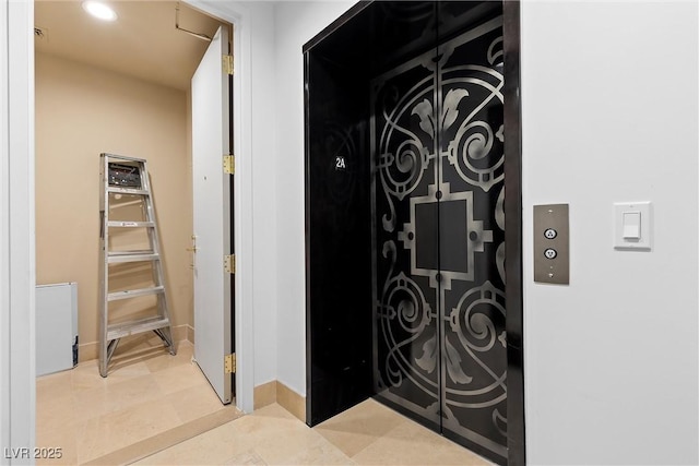 interior details featuring elevator and recessed lighting