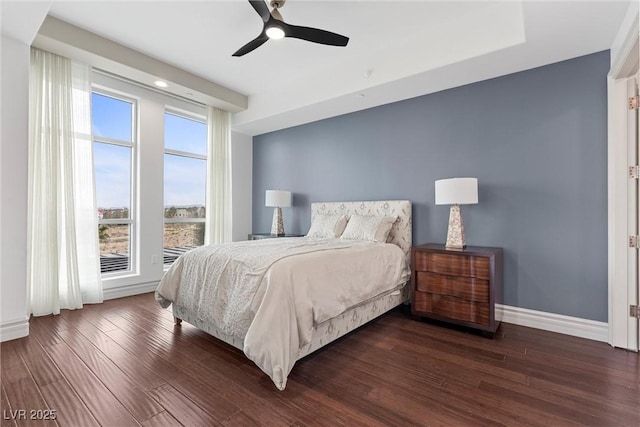 bedroom featuring dark wood-style floors, ceiling fan, and baseboards