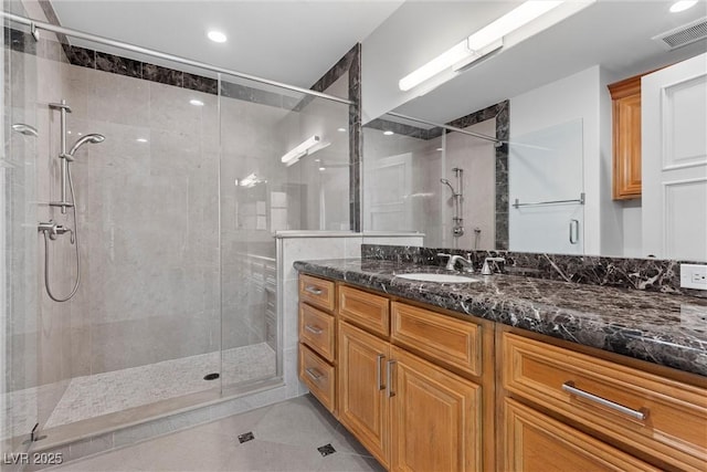 full bath with visible vents, a stall shower, and vanity