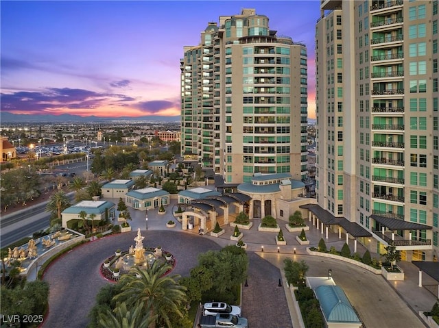 property at dusk featuring a view of city and driveway