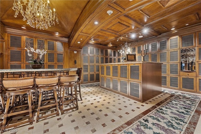 wine cellar featuring a dry bar, wood ceiling, vaulted ceiling, ornamental molding, and an inviting chandelier