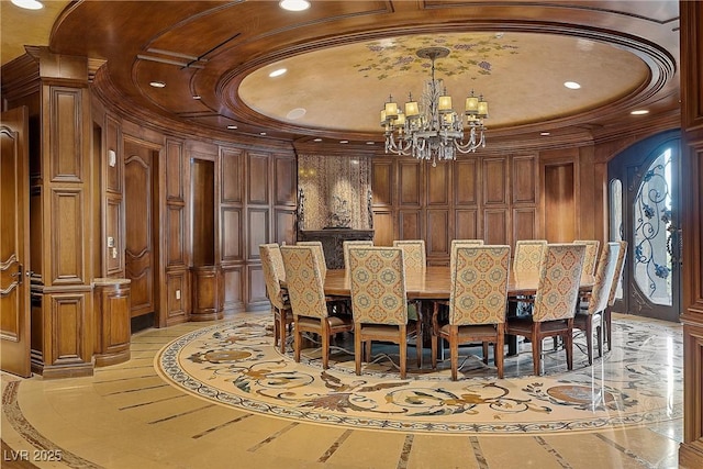 dining room featuring a notable chandelier, recessed lighting, arched walkways, crown molding, and a raised ceiling