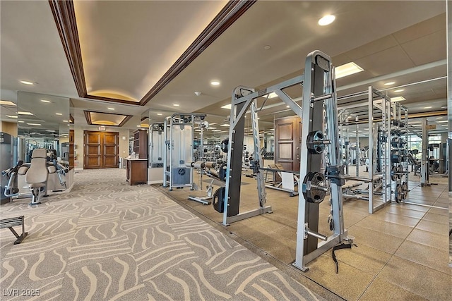 gym featuring recessed lighting and a raised ceiling