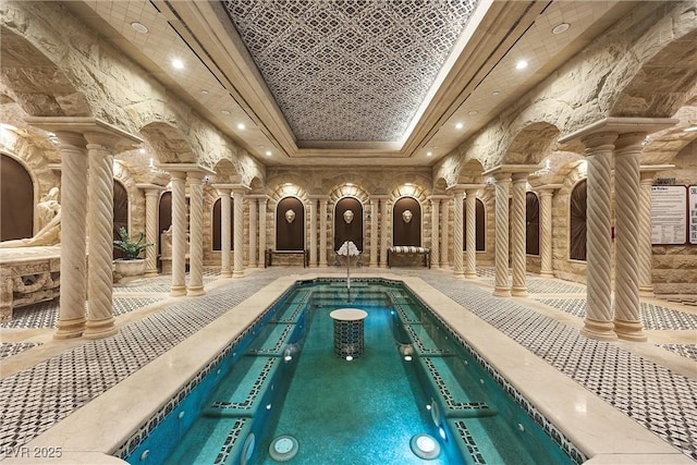 pool featuring decorative columns