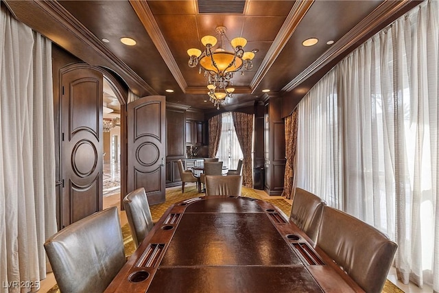 dining area with visible vents, a notable chandelier, arched walkways, crown molding, and a raised ceiling