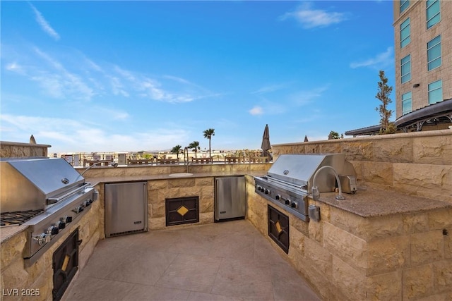 view of patio / terrace with grilling area and an outdoor kitchen