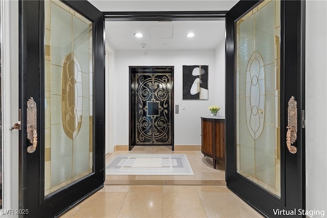 tiled foyer featuring recessed lighting and baseboards