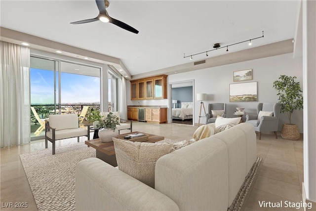 living area with visible vents, a ceiling fan, wine cooler, rail lighting, and light tile patterned floors