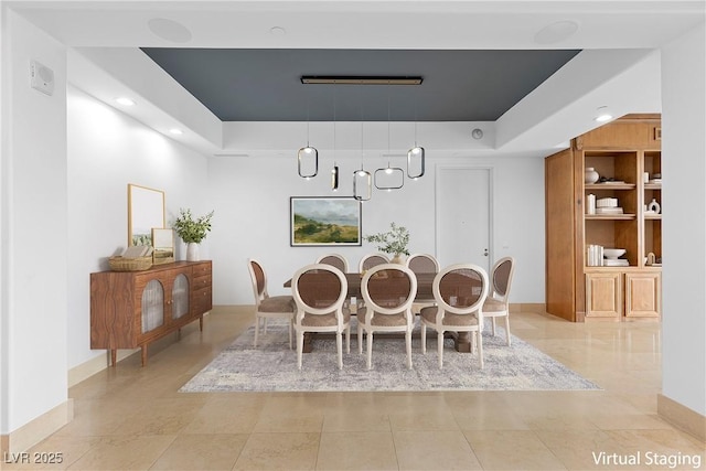 dining area with recessed lighting, baseboards, and a raised ceiling