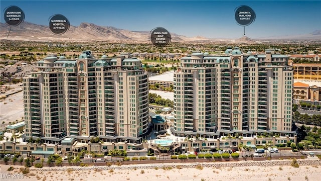 view of property with a mountain view and a view of city