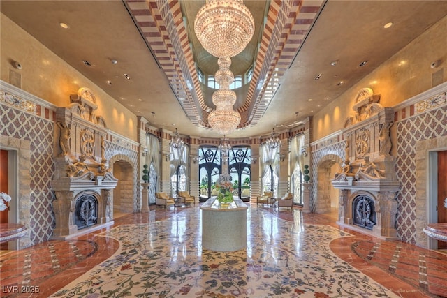 unfurnished living room featuring arched walkways, a fireplace with raised hearth, a high ceiling, and an inviting chandelier