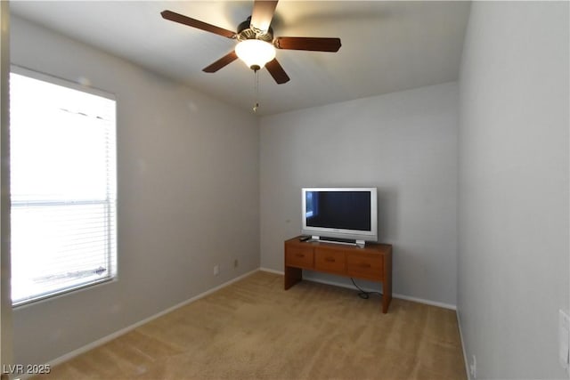 bedroom with light carpet, a ceiling fan, and baseboards