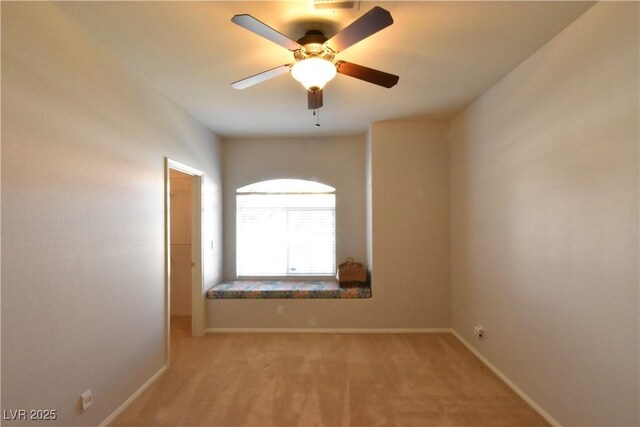 unfurnished room with baseboards, light carpet, and a ceiling fan