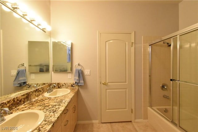 full bath featuring tile patterned flooring, double vanity, shower / bath combination with glass door, and a sink