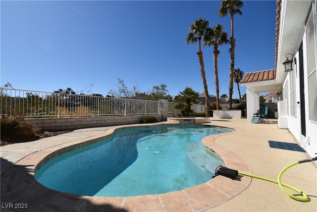 view of pool with a pool with connected hot tub, a fenced backyard, and a patio area