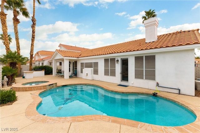 view of swimming pool featuring an in ground hot tub, a fenced in pool, and a patio