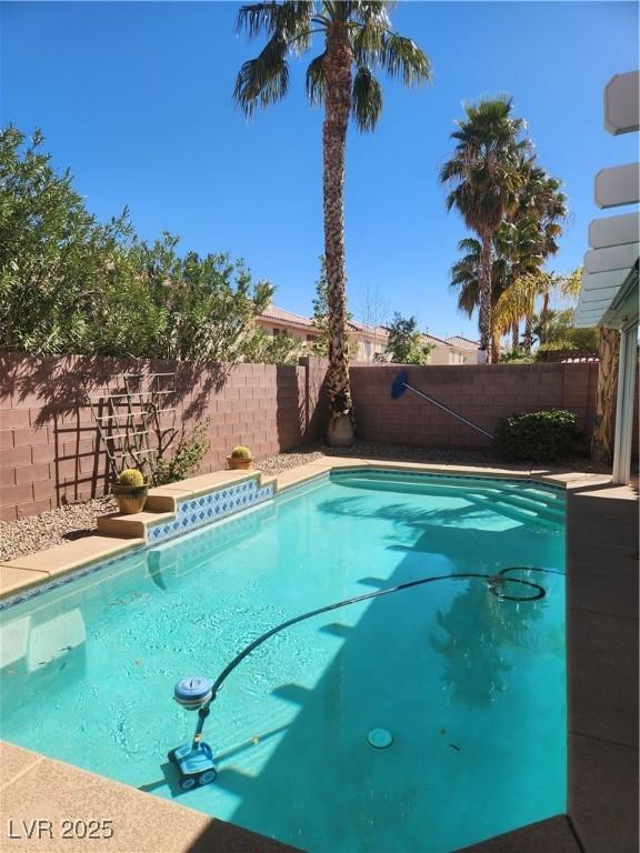 view of swimming pool with a fenced in pool and a fenced backyard