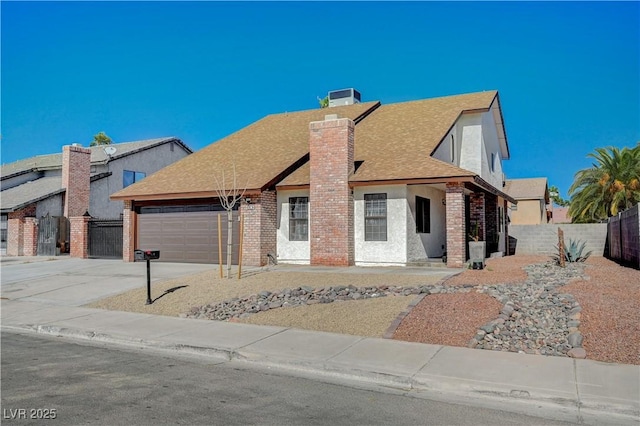 view of front of home with fence, an attached garage, a shingled roof, a chimney, and concrete driveway