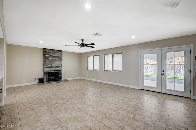 unfurnished living room featuring a ceiling fan, visible vents, baseboards, a fireplace, and french doors