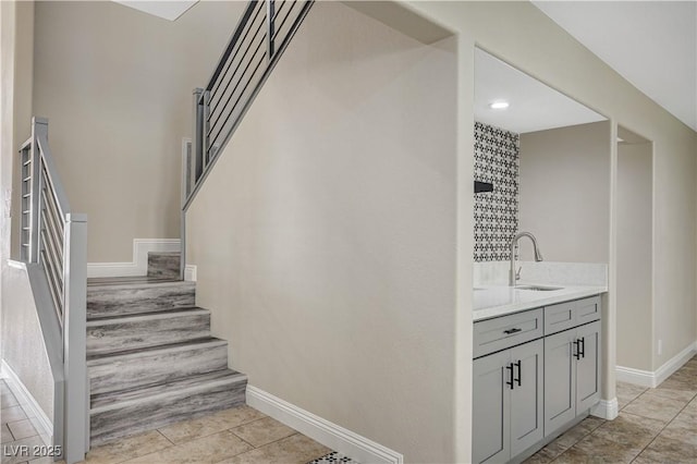 stairway featuring tile patterned floors and baseboards