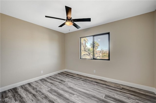 unfurnished room featuring wood finished floors, baseboards, and ceiling fan