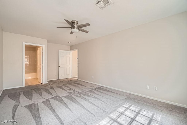 unfurnished bedroom featuring visible vents, ensuite bathroom, a ceiling fan, carpet, and baseboards