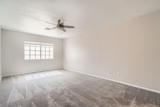 empty room featuring a ceiling fan, visible vents, carpet floors, and baseboards