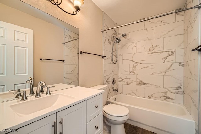 full bath featuring toilet, vanity, bathing tub / shower combination, and wood finished floors