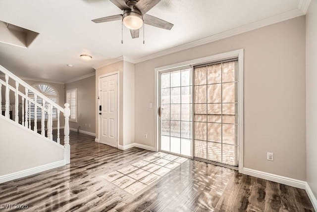 foyer entrance with crown molding, stairs, baseboards, and wood finished floors