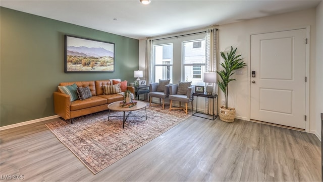 living room featuring baseboards and wood finished floors