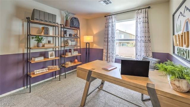 carpeted home office featuring visible vents and baseboards