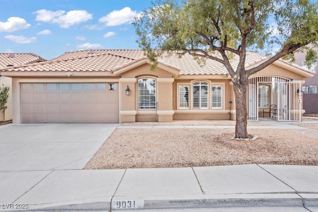 view of front of property featuring a tiled roof, stucco siding, an attached garage, and driveway