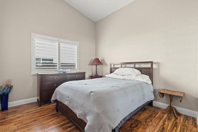 bedroom with lofted ceiling, wood finished floors, and baseboards