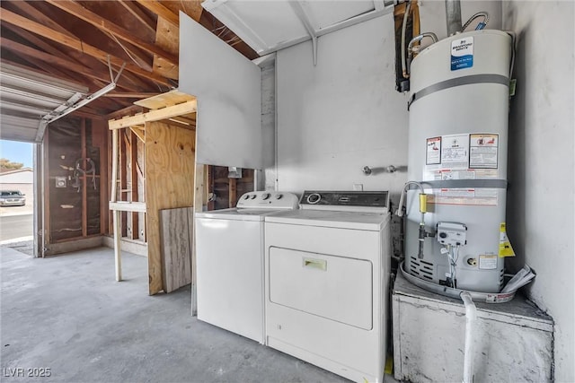 washroom featuring laundry area, water heater, and washer and clothes dryer