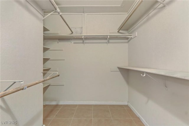 spacious closet featuring light tile patterned flooring