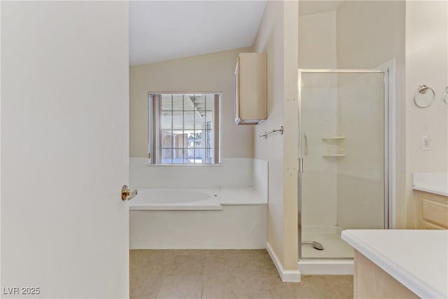 full bathroom with a shower stall, tile patterned flooring, lofted ceiling, a bath, and vanity