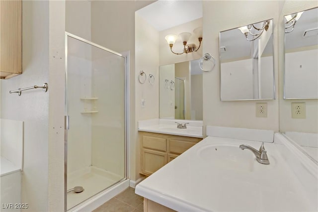 full bath with tile patterned floors, a stall shower, and vanity