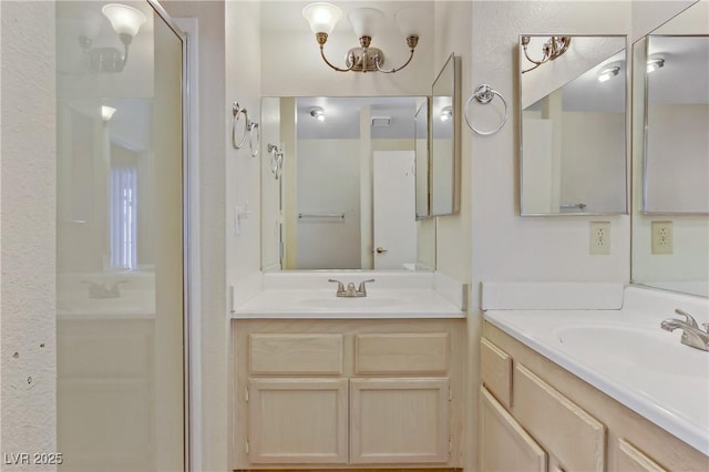 full bathroom with a sink, visible vents, two vanities, and a shower stall