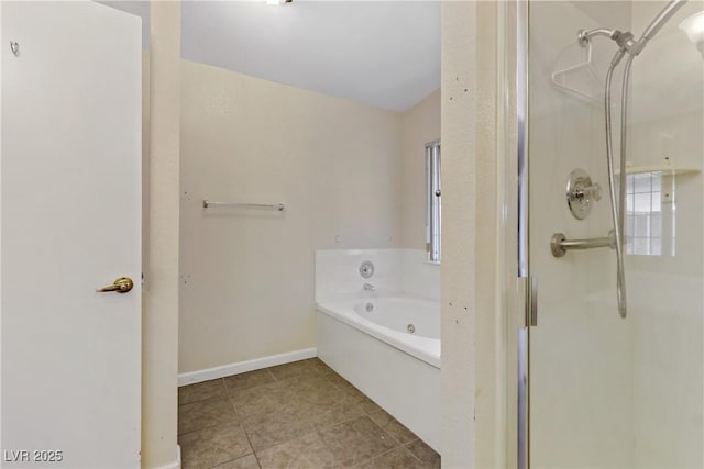 bathroom with baseboards, a bath, a shower stall, and tile patterned flooring