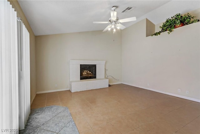 unfurnished living room featuring visible vents, a brick fireplace, baseboards, and vaulted ceiling