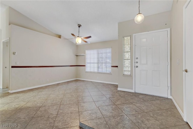 entrance foyer featuring tile patterned flooring, lofted ceiling, baseboards, and ceiling fan