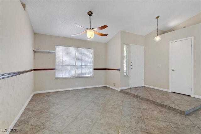 tiled foyer entrance featuring a ceiling fan, baseboards, and vaulted ceiling