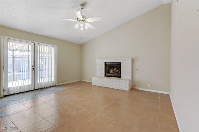 unfurnished living room featuring light tile patterned floors, french doors, a fireplace, and vaulted ceiling