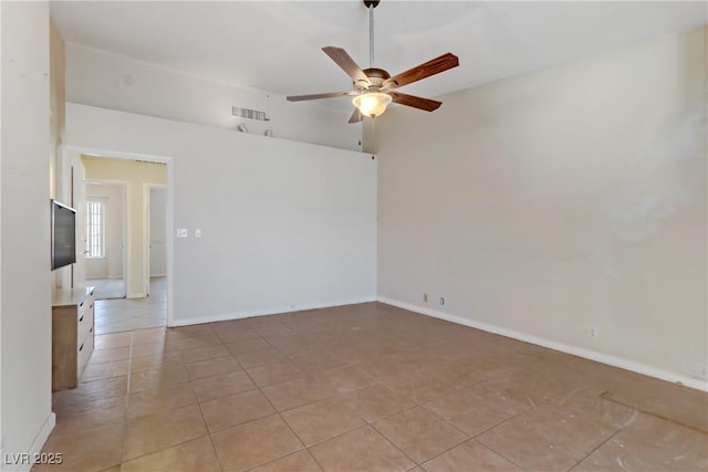 empty room featuring light tile patterned floors, visible vents, baseboards, and a ceiling fan