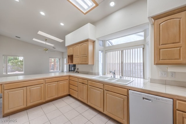 3710 E Oquendo Rd, Las Vegas, NV 89120 - kitchen featuring white dishwasher, a sink, light brown cabinetry, lofted ceiling, and a peninsula