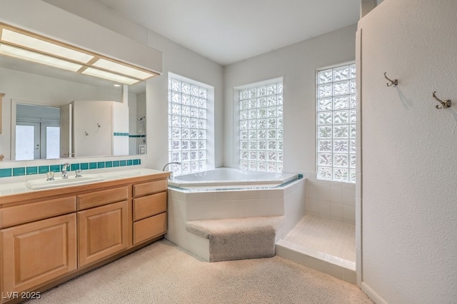 3710 E Oquendo Rd, Las Vegas, NV 89120 - bathroom with plenty of natural light, a tile shower, a bath, and vanity