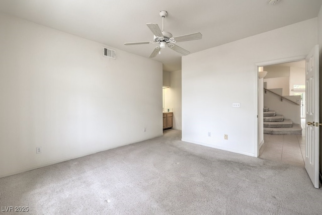 unfurnished bedroom featuring light colored carpet, visible vents, and connected bathroom